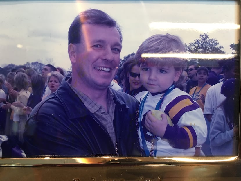 A framed photo behind Fisher's desk, when Fisher was an assistant at LSU. He is holding...
