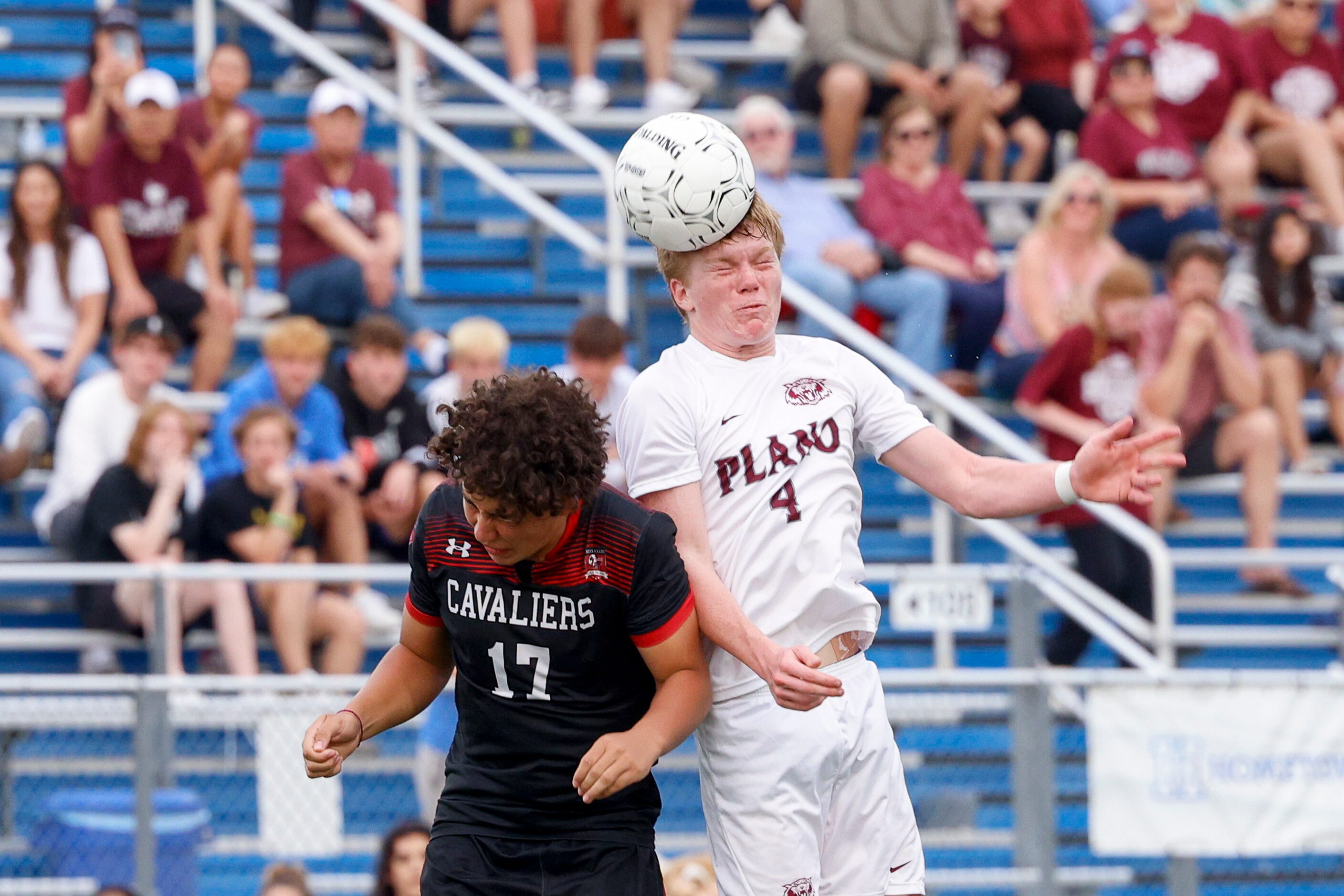 Plano midfielder Steven Wood (4) jumps for a header over Austin Lake Travis midfielder...