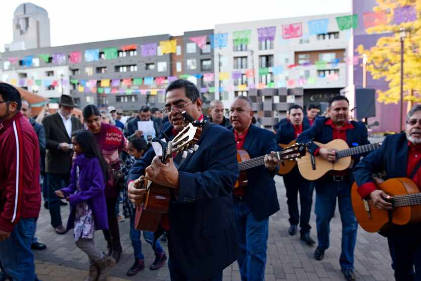 Rondalla Romántica musicians lead the Posada processioin at the Latino Cultural Center.