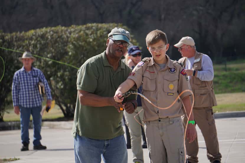 Alfred Hillman teaches Zachary Bruce how to cast during Flyfest at River Park Trailhead in...