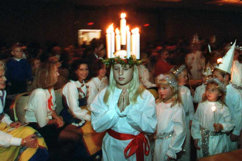 A girl wears a crown of candles during a St. Lucia celebration.