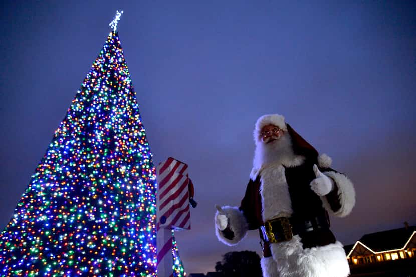 Santa gives a thumbs up after pulling a lever to light the Christmas tree at Castle Hills...
