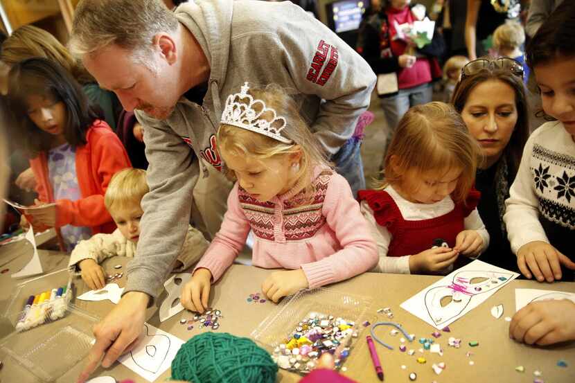 Families make paper masks during a Noon Year's Eve Party.