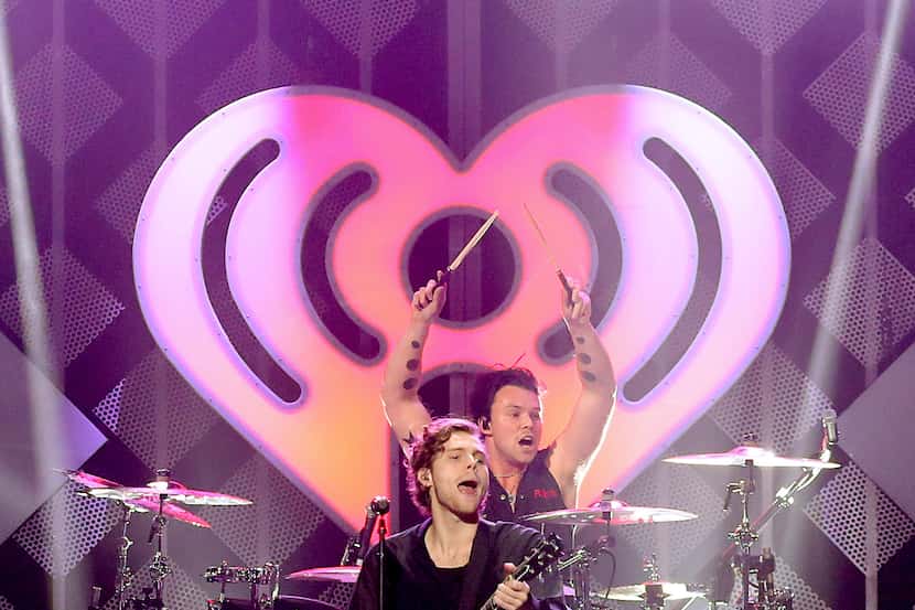 Ashton Irwin and Luke Hemmings of 5 Seconds of Summer performs onstage during KISS 108's...