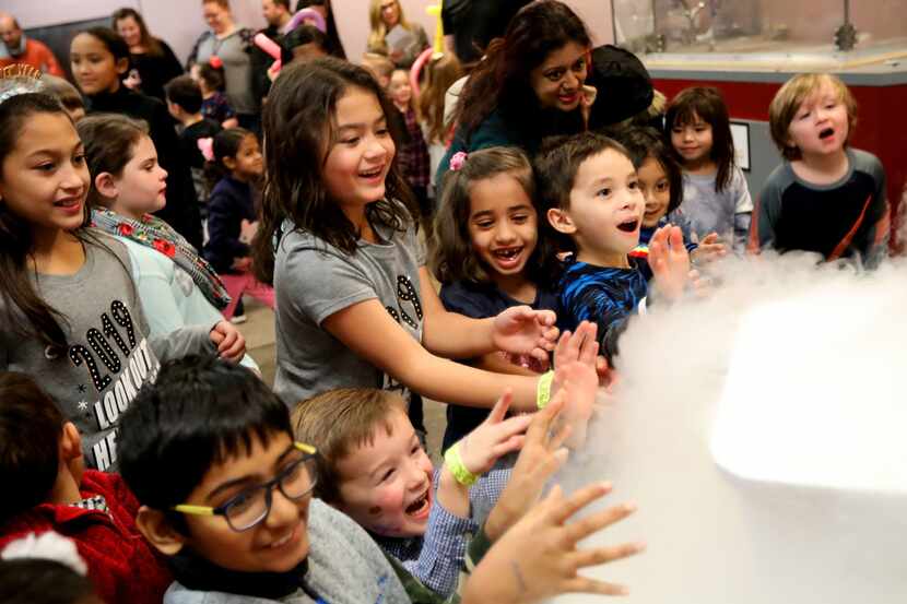 Children watch a liquid nitrogen demonstration at the Sci-Tech Discovery Center in Frisco.