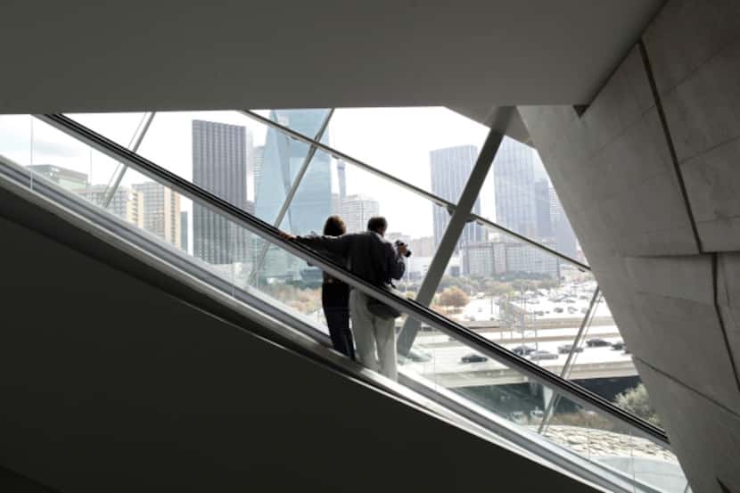 A couple enjoys the view as they ride the escalator at he Perot Museum of Nature and Science...