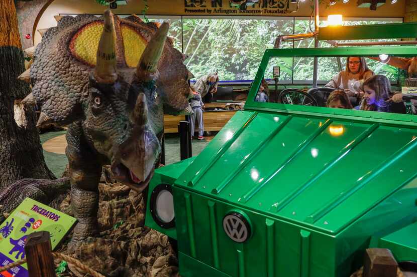 A Triceratops and safari Jeep