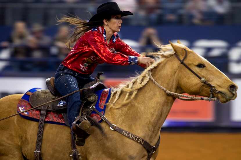 A rodeo rider competes in barrel racing.