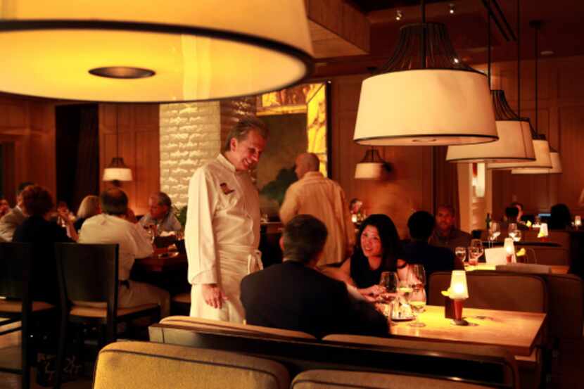 Chef Dean Fearing talks to patrons Selena Lacroix of Dallas and Nicola Gavazzi of Milan in...