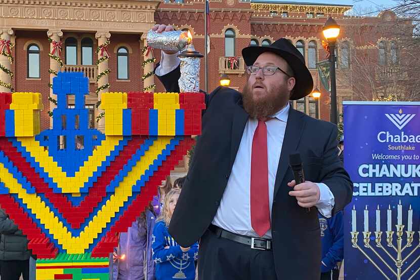 Rabbi Levi Gurevitch of Chabad of Southlake lights a menorah made of Legos.