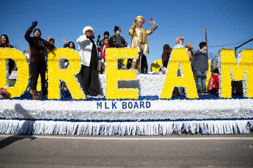 The MLK Board waves as they make their way down Martin Luther King Jr. Blvd during the 38th...