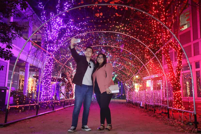 Moses Figueroa, left, and Lidia Calderon take a selfie during Radiance: Frozen, a holiday...