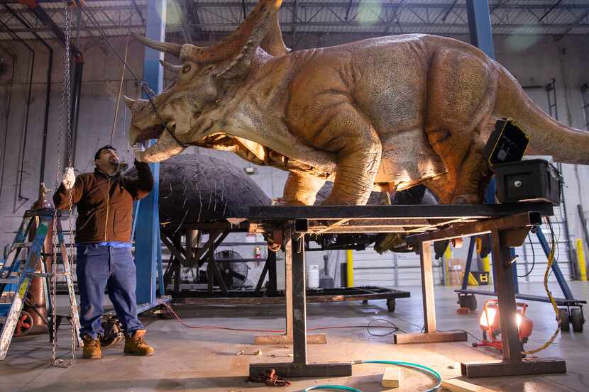 Alberto Hernandez checks the movement of a dinosaur at Billings Productions, an animatronic...