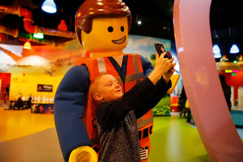Zachary Peltonen takes a selfie with Emmet at Legoland Discovery Center at Grapevine Mills...