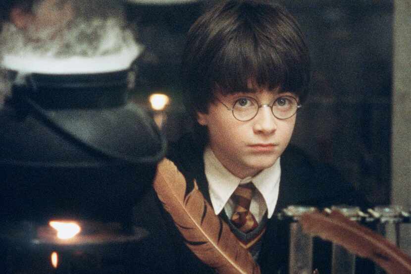 Actor Daniel Radcliffe writes with a quill in a scene from  'Harry Potter and the Sorcerer's...