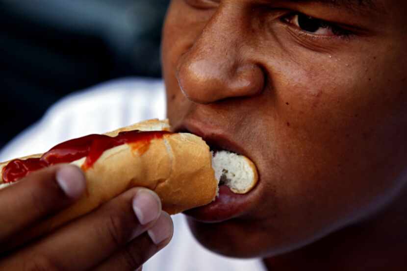 Stody Bradley bites into a hot dog on Dollar Hot Dog Night at the ballpark.
