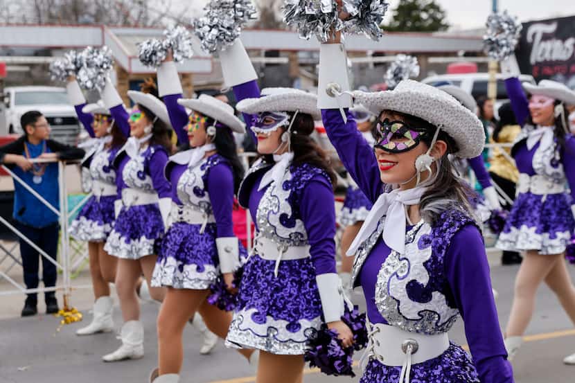 Members of the Sunset High School Bisonettes march during the annual Oak Cliff Mardi Gras...