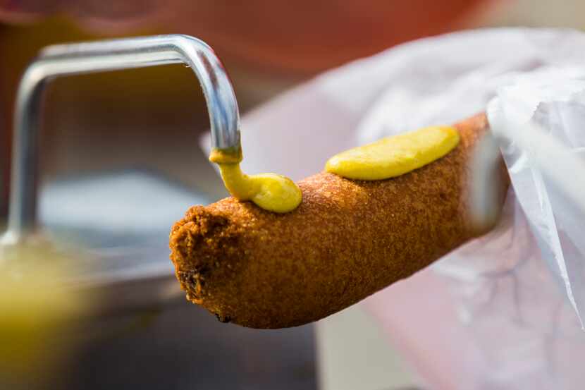 Mustard is applied to a Fletcher's Corny Dogs.