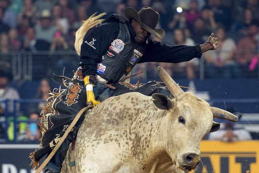 Professional bull rider Juliano Antonio Da Silva rides bull Lester Gillis during the...
