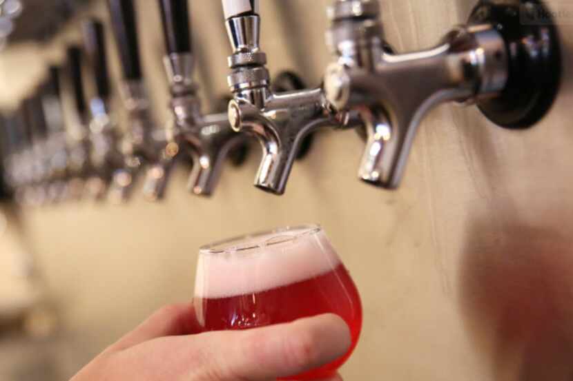 Beertender Byron Canulla fills a draft beer at the Bearded Monk in Denton, Texas on Aug. 25,...