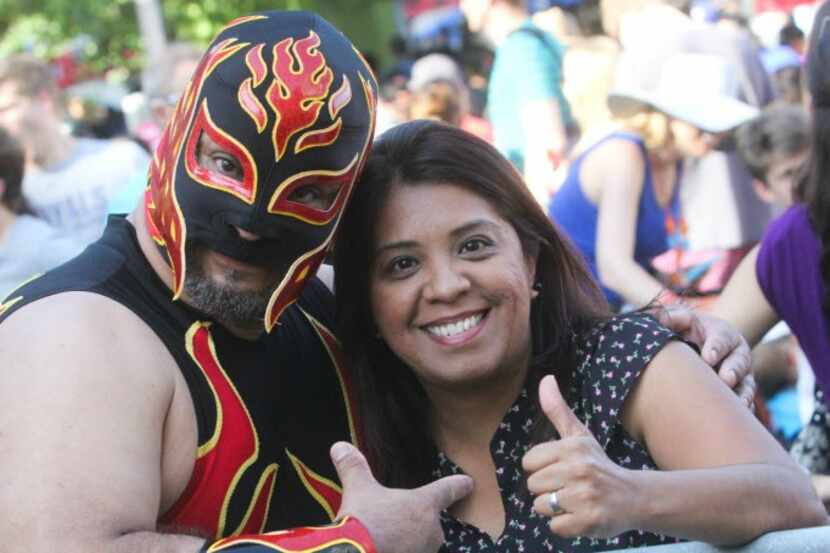 Lucha Libre wrestler is photographed with a fan at the 2nd Annual Taco Libre on April 30....