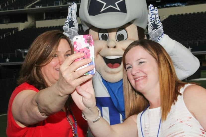 Cowboys mascot Rowdy and two fans at the 12th annual Taste of the NFL at AT&T Stadium on May...