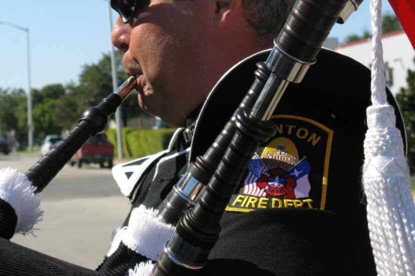 Capt. Chuck Howell from the Denton Fire Department practices the bagpipes before the...