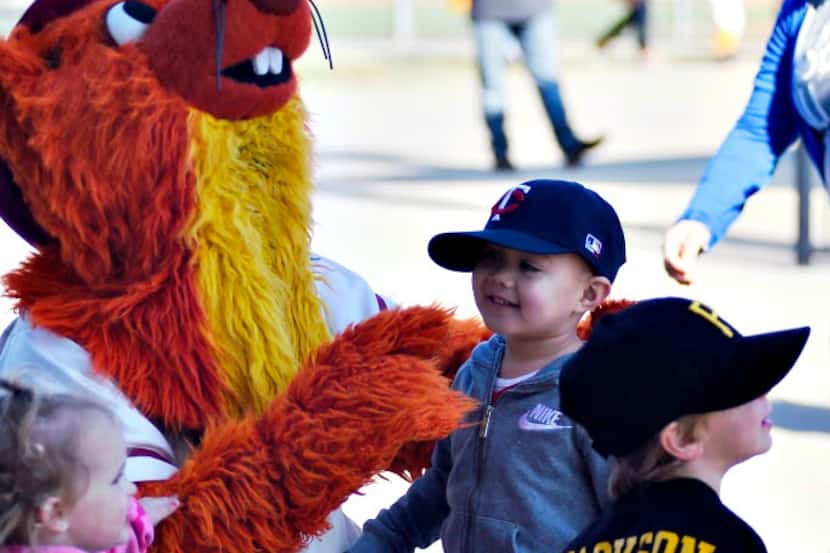 Children pose for a picture with Frisco RoughRiders mascot Deuce. 