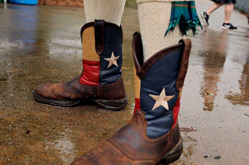 Chuck Newell of Fort Worth stands in a puddle at the Texas Scottish Festival and Highland...