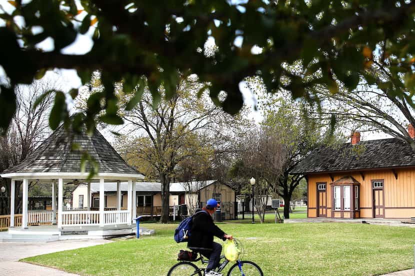 Kenny Smith rides his bike through Heritage Park in Irving.