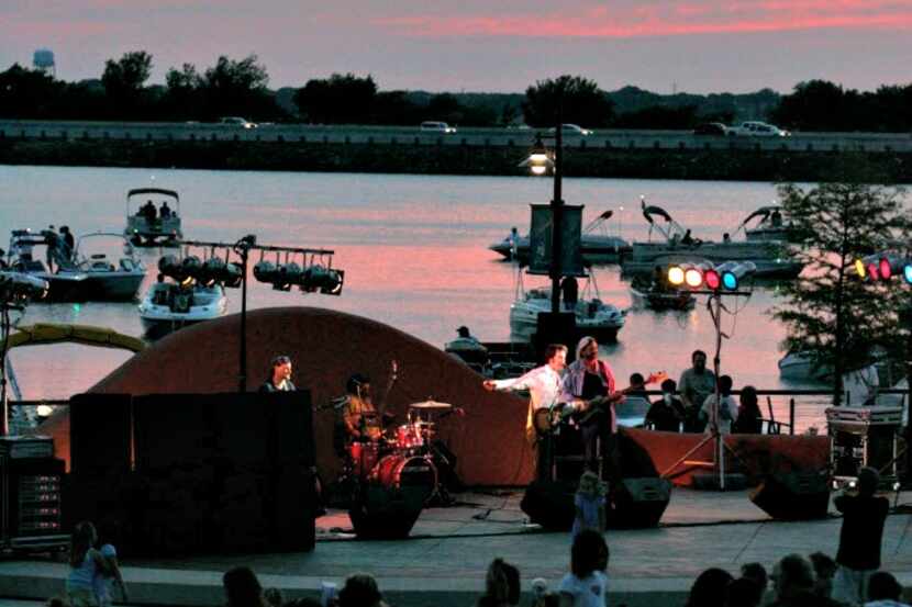 A band plays as the sun sets at the Concerts by the Lake at The Harbor in Rockwall.