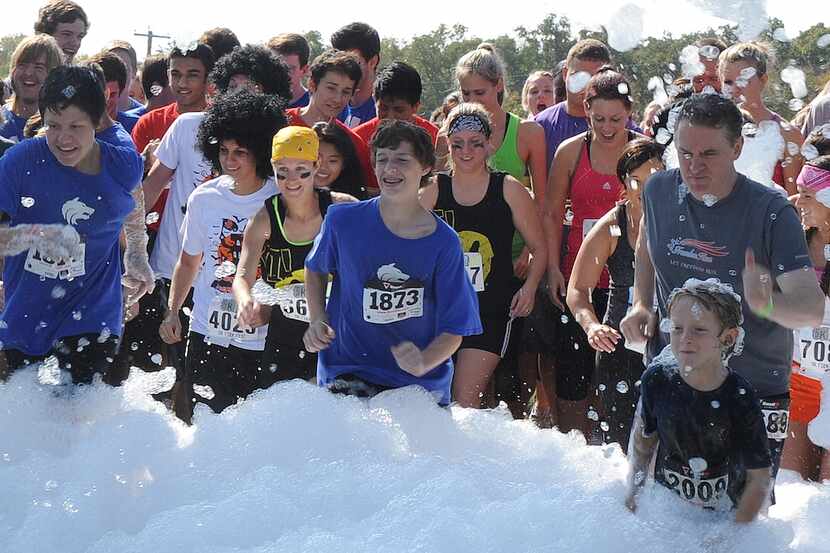 Runners begin their foamy trek toward the finish line at the Foam Fest 5K.