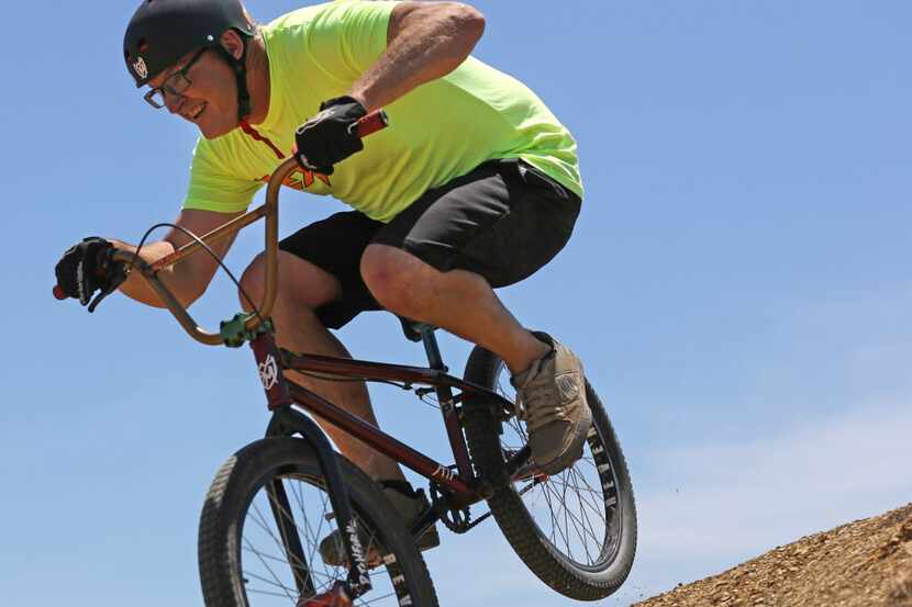 A professional BMX racer performs a jump on the bike course at TexPlex Park. 