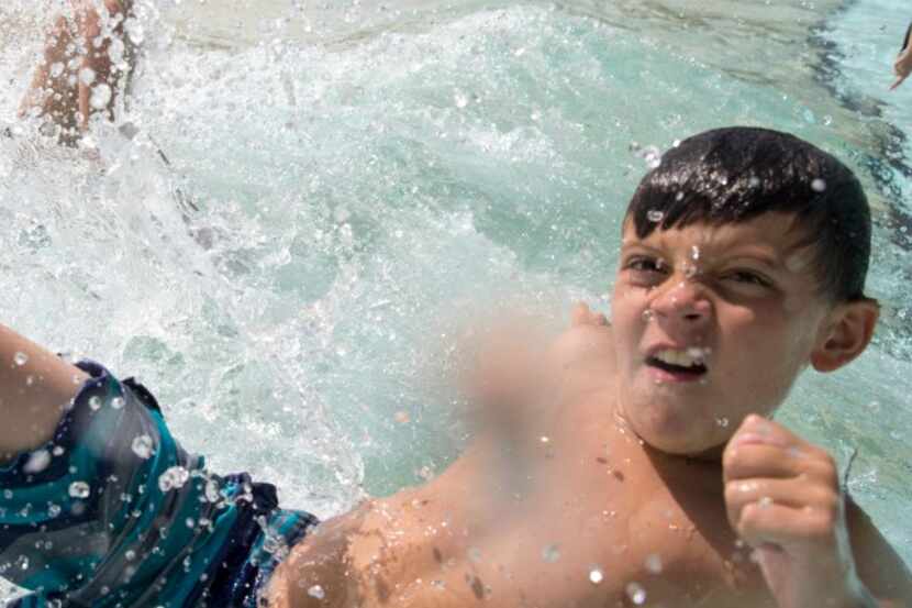 Kids play in the wave pool at NRH2O Family Water Park in North Richland Hills. 