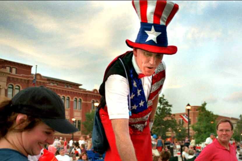 Uncle Sam on stilts greets the crowd during the Southlake Stars and Stripes festival at...