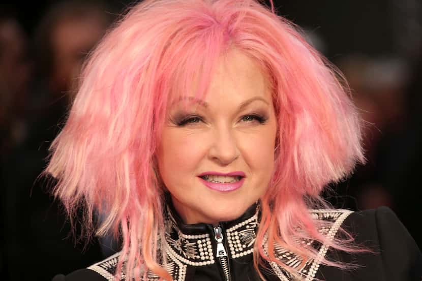 Actress and singer Cyndi Lauper poses for photographers upon arrival at the Olivier Awards...