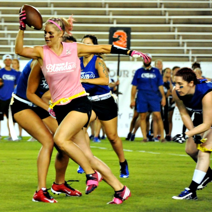 Team captain Lindsey Kluempers runs with the ball at the 2016 Blondes vs. Brunettes powder...