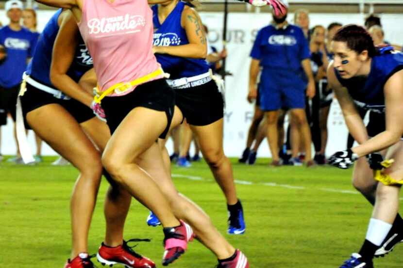 Team captain Lindsey Kluempers runs with the ball at the 2016 Blondes vs. Brunettes powder...