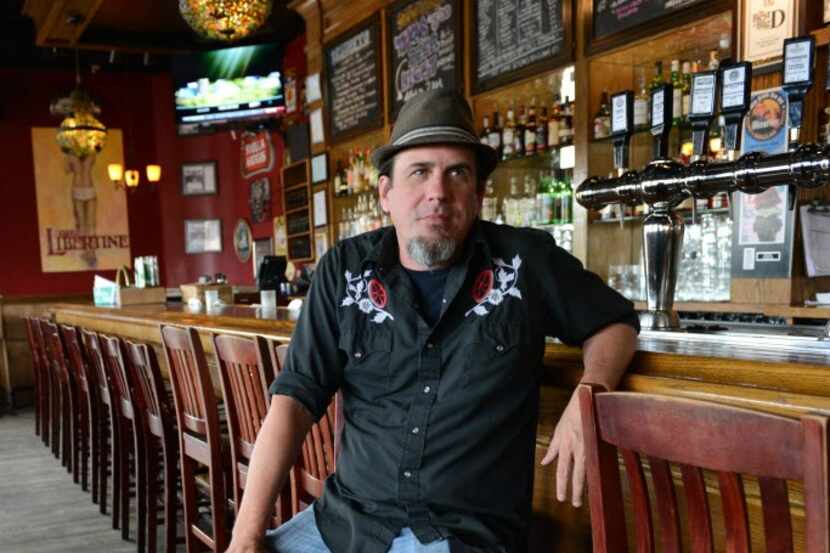 Libertine Bar owner Simon McDonald poses for a portrait in his business on Lower Greenville.