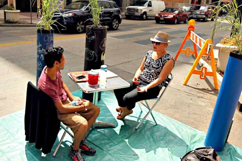 Park(ing) Day Dallas participants transform metered parking spaces along Main Street into...