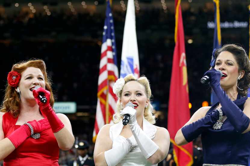 The Victory Belles sing the National Anthem before an NFL football game.