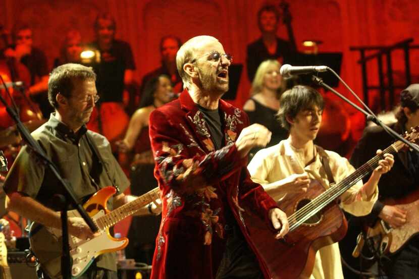 Ringo Starr sings with Eric Clapton (left) and Dhani Harrison (right) on guitars at The...