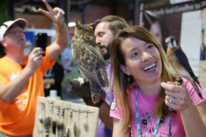 Lindsey McNeny, of the bird education program Window to the Wild, holds an American kestrel...