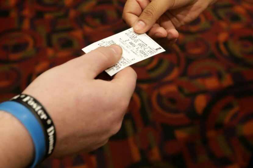 Movie ticket exchanges hands.