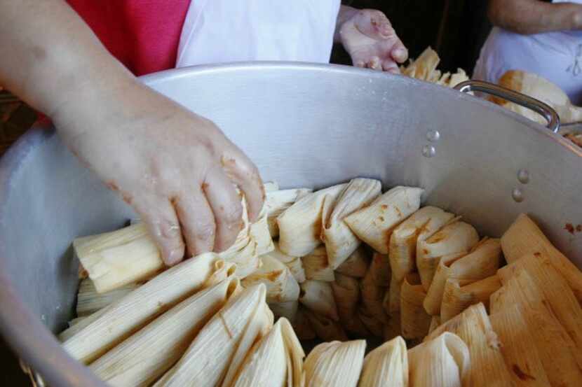 Tamales are placed in the cooking pot at Luna's Tortilla Factory.