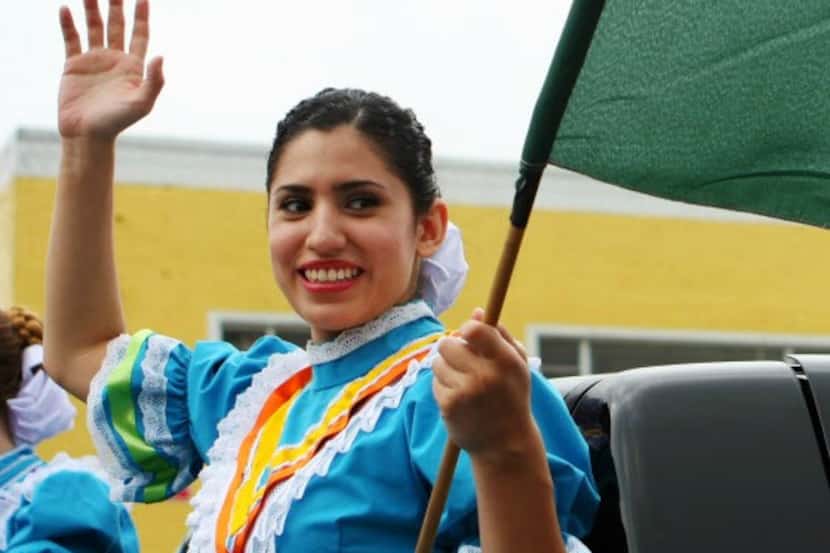 A folkorico dancer waves during a Cinco de Mayo parade.