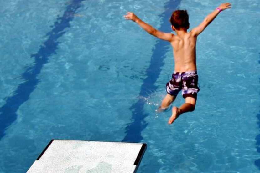 A boy  jumps off the low dive at Sun Valley Aquatic Center in Lewisville.