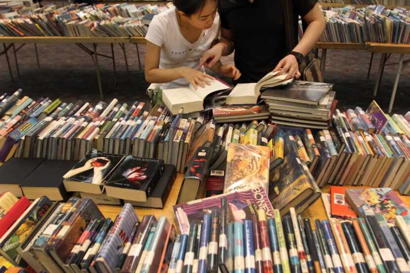 Patrons browse at a library book sale.