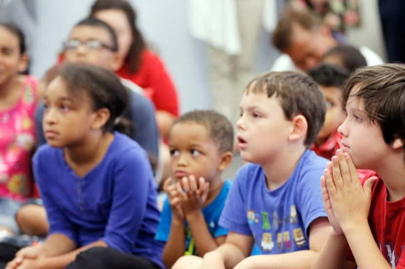 Children listen during an event at the Arlington public library.