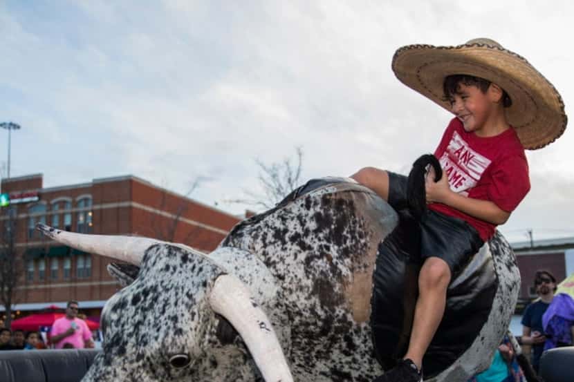 Tres Zapata rides a mechanical bull during TexFest.